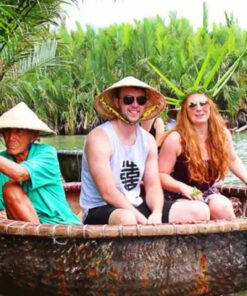 Tourists enjoying a traditional Vietnamese basket boat ride through the lush Bay Mau Coconut Forest in Hoi An with a local guide.