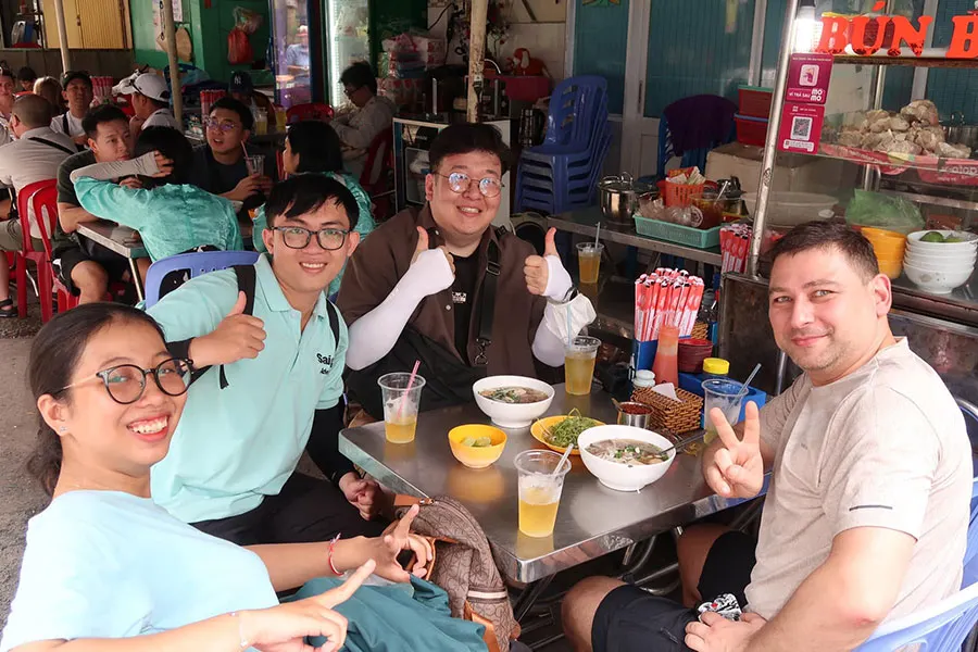 Saigon walking food tour featuring local family-run street food stalls and hidden gems.