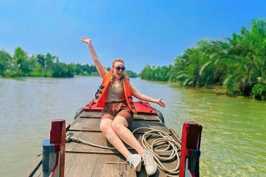 Visitors enjoying a scenic boat trip through the waterways of the Mekong Delta region.