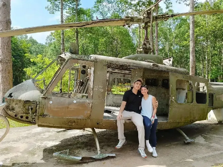 Unforgettable moments in history! Capture your own unique photo on top of a historic American helicopter wreckage at the Cu Chi Tunnels. Book your full-day adventure with Saigon Adventure to see where old history meets modern memories!