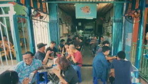 Local patrons enjoying traditional cloth-filter coffee at Cheo Leo Cafe, the oldest coffee shop in Ho Chi Minh City, during a private motorbike tour.