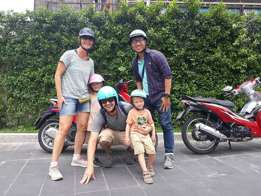 Travelers exploring Ho Chi Minh City like a local by scooter