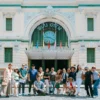 Tourists visiting Saigon Central Post Office on a street food and sightseeing scooter tour