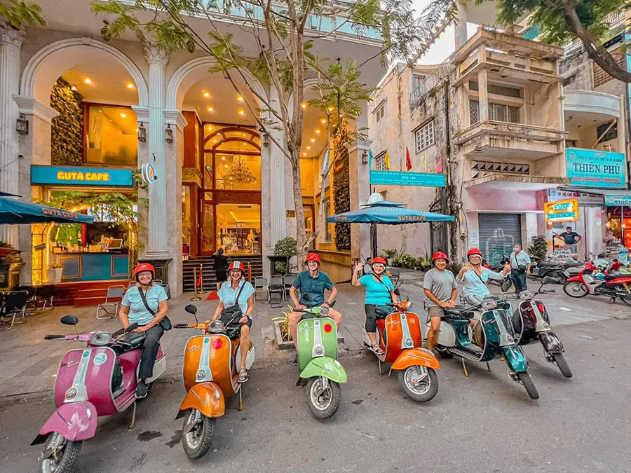 Motorbike Tours in Ho Chi Minh City with foreign tourists and Saigon Adventure guides exploring iconic Saigon landmarks