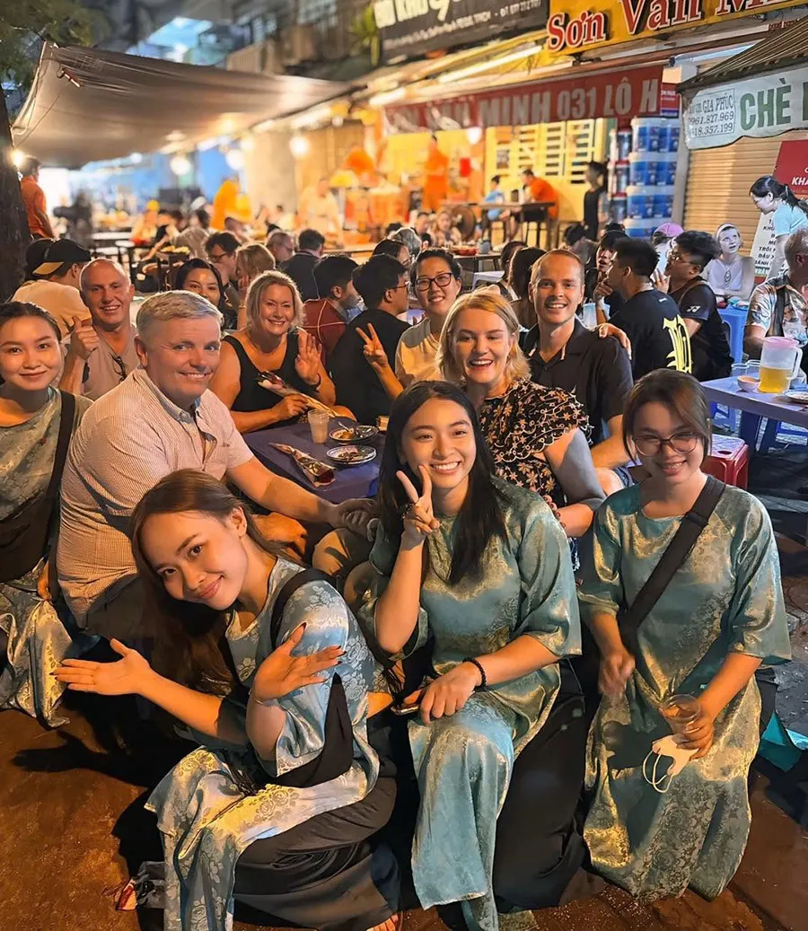 Saigon Food Tour guests enjoying authentic Vietnamese street food