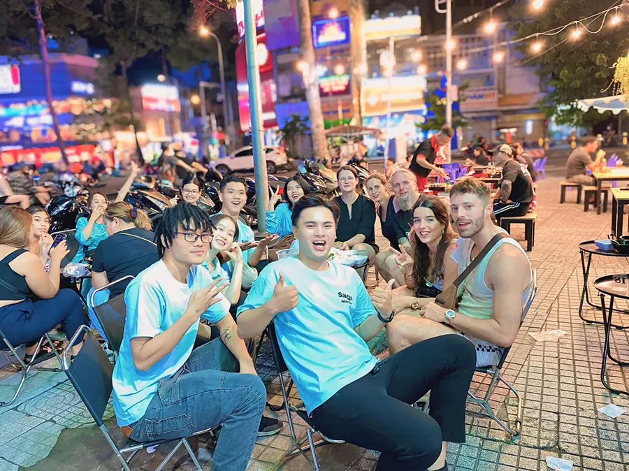 Travelers enjoying a memorable Saigon Food Tour along the streets of Saigon