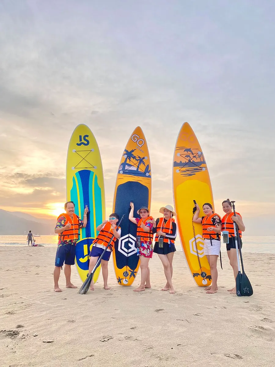 Visitors enjoying the beautiful shoreline of My Khe Beach in Da Nang, Vietnam