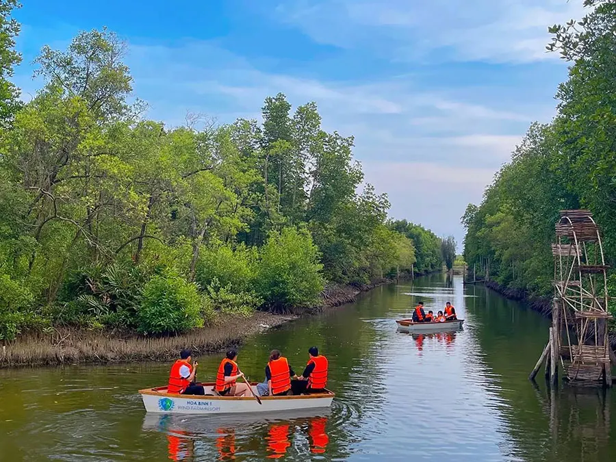 Tourists go canoeing to explore the coastal mangrove forests of Bac Lieu.
