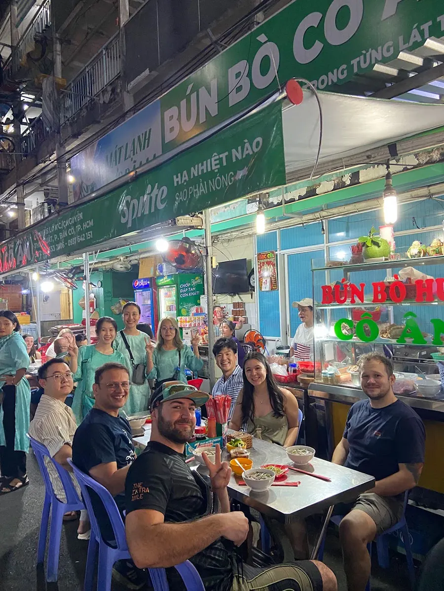 Michelin Street Food Tour in Ho Chi Minh City with tourists enjoying authentic Vietnamese street food