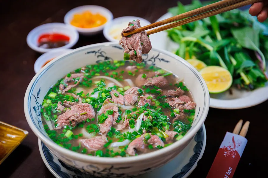 Experience the rich taste of traditional Pho, a must-try Vietnamese street food.