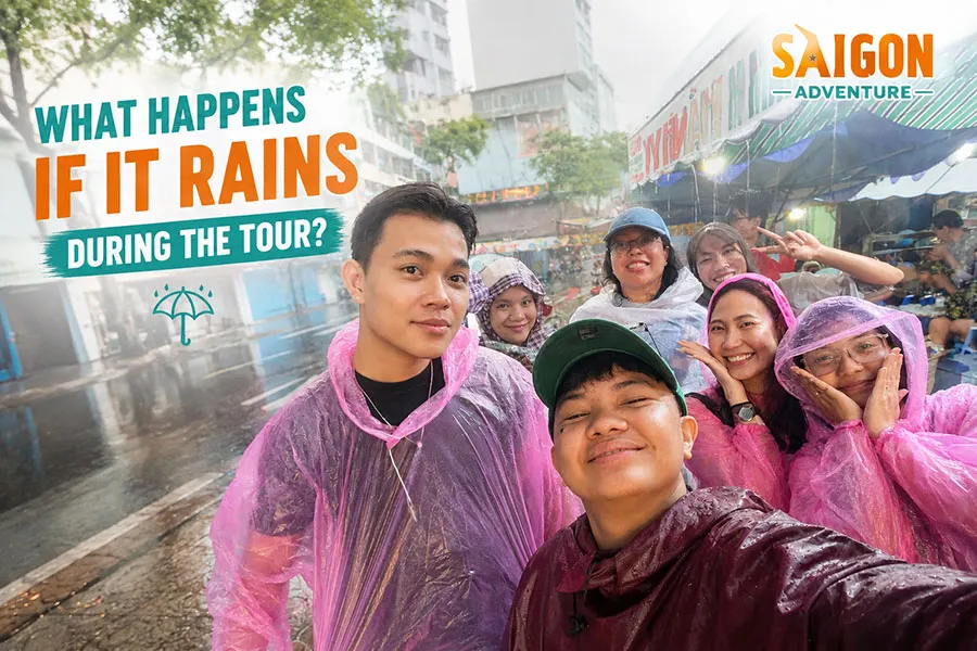 Tourists wearing rain ponchos enjoying a Saigon Adventure motorbike tour in the rain in Ho Chi Minh City