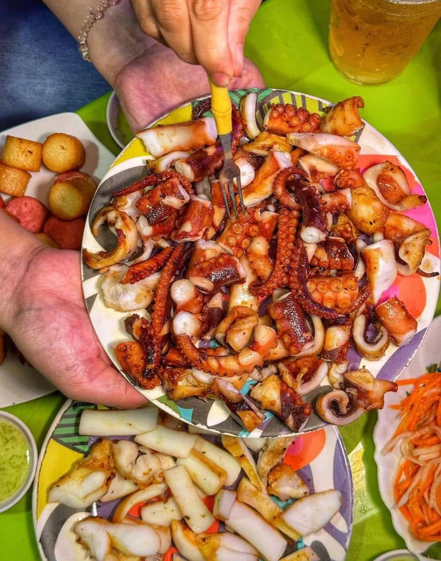 District 4 Food Tour: Explore Saigon’s Paradise for Snails and Street Seafood 4 The smoky aroma of grilled octopus drifting through a Saigon night market is almost impossible to walk past