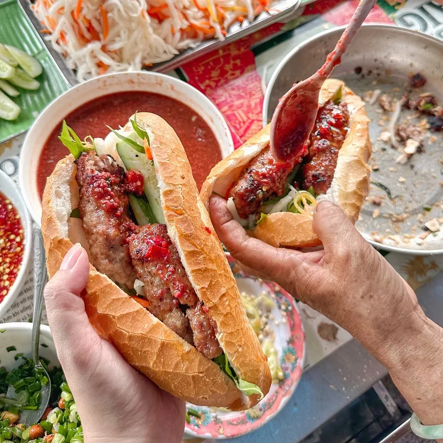 Is Street Food in Ho Chi Minh City Spicy? 3 Bánh mì sandwich with grilled pork and fresh vegetables, served with chili that can be removed for a milder taste