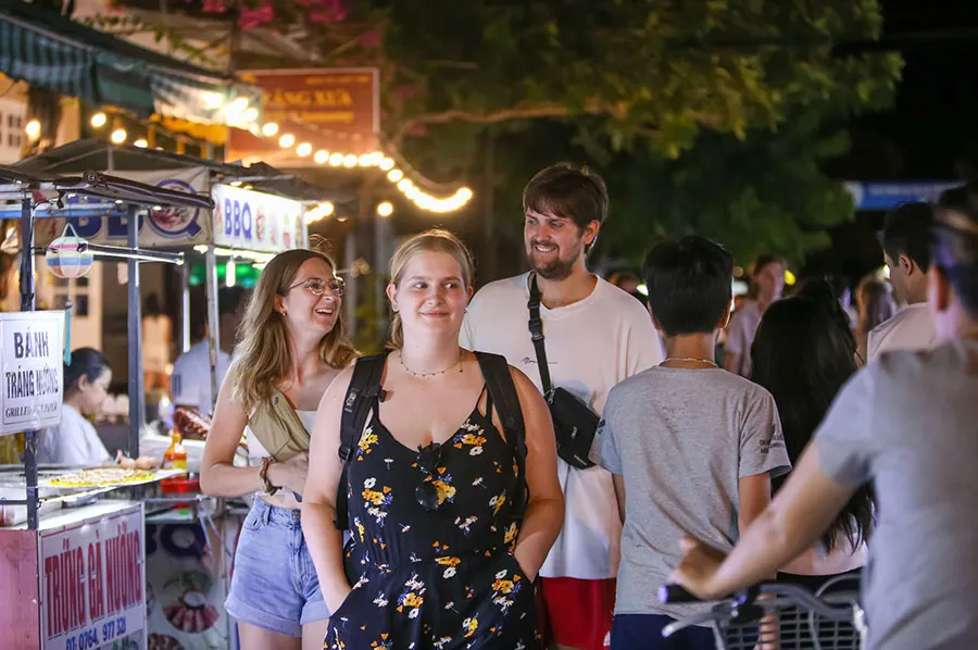 7 Best Street Food Cities in Vietnam for Food Lovers 2 Visitors enjoy exploring famous street food in Hoi An Ancient Town.