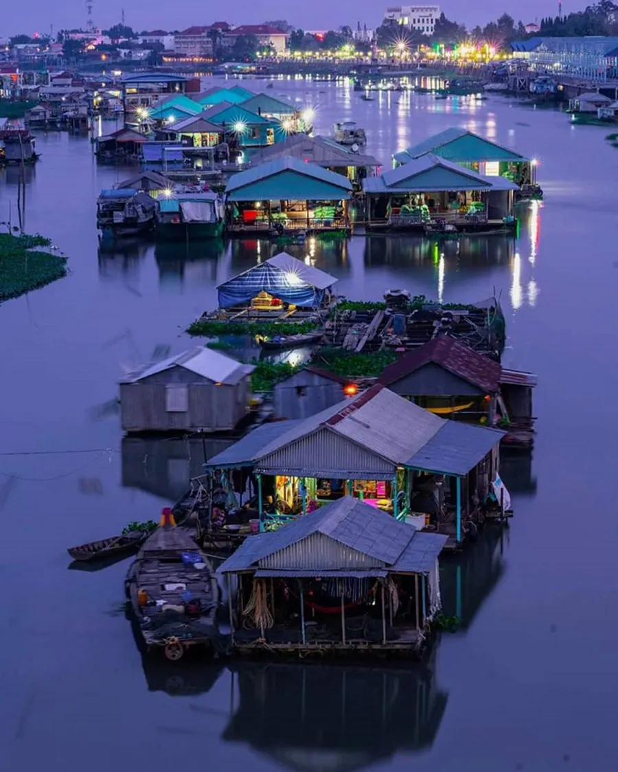 Is Chau Doc Worth Visiting on a Mekong Delta Trip? 2 Sparkling night view of An Giang floating village along the peaceful river.