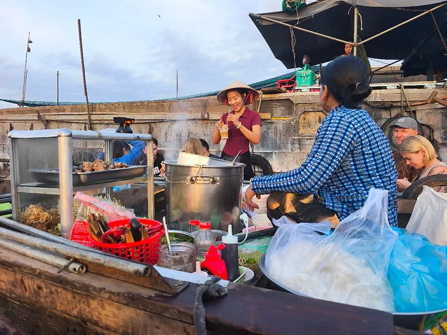Cai Rang Floating Market: Complete Visitor Guide 4 Explore Cai Rang Floating Market at sunrise, photograph the Mekong River scenery and enjoy breakfast from a local boat