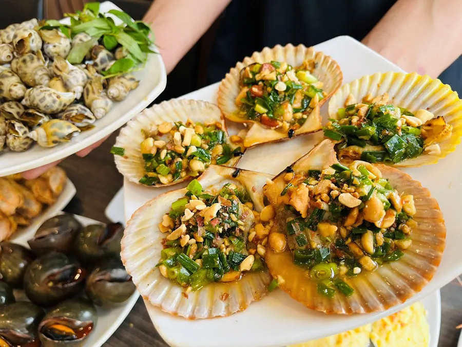 District 4 Food Tour: Explore Saigon’s Paradise for Snails and Street Seafood 1 Try grilled scallops with scallion oil in Saigon and you may fall in love after the first bite