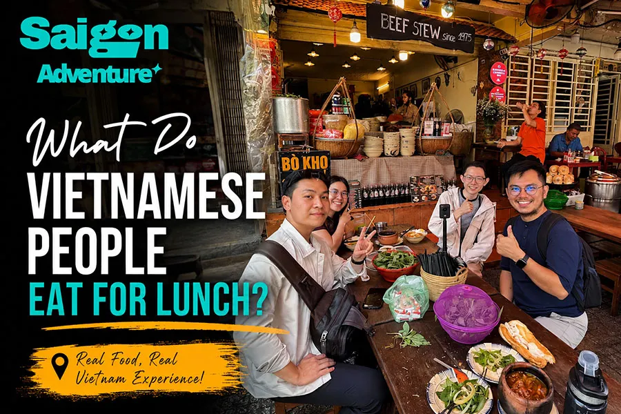 What Do Vietnamese People Eat for Lunch? A Local Food Guide 2 Tourists enjoying a traditional Vietnamese lunch at a local restaurant in Ho Chi Minh City