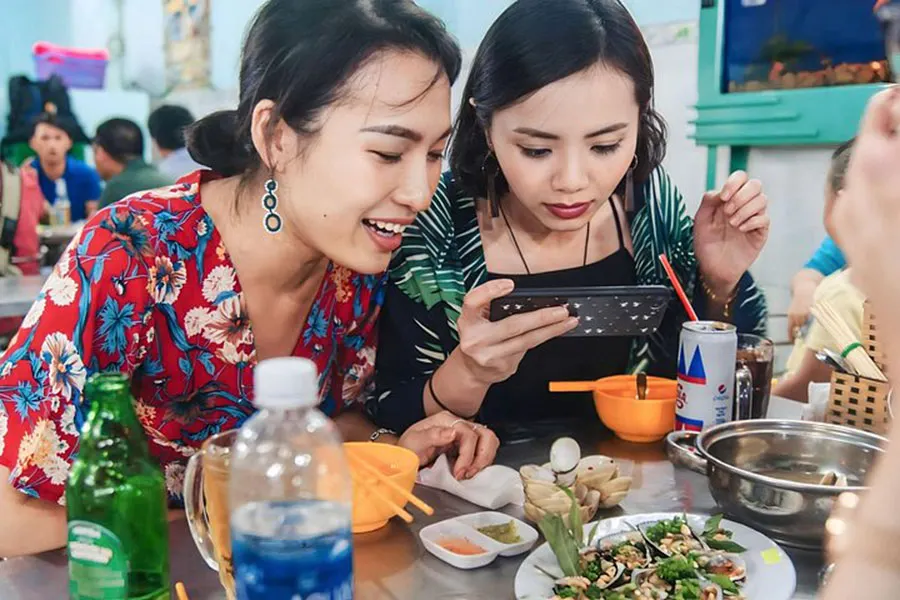 How to Eat Street Food Safely in Ho Chi Minh City: A Practical Traveler’s Guide 7 International visitors tasting spicy Vietnamese snails for the first time