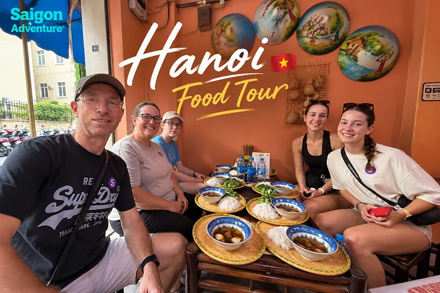 Where to Stay in Hanoi for Food Lovers: 5 Best Areas for Local Eating 3 Hanoi street food tour with travelers enjoying noodles and Vietnamese specialties