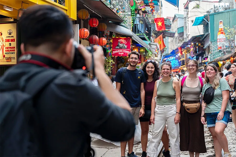 Is Hanoi Train Street Worth Visiting? An Honest Guide for First-Time Travelers 5 Visitors creating lasting memories at the famous Hanoi Train Street