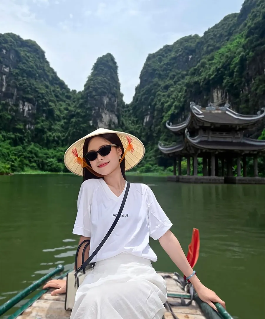 Hoa Lu Ancient Capital Guide: History, Temples and Travel Tips 4 International visitors admiring Trang An’s UNESCO-listed karst scenery