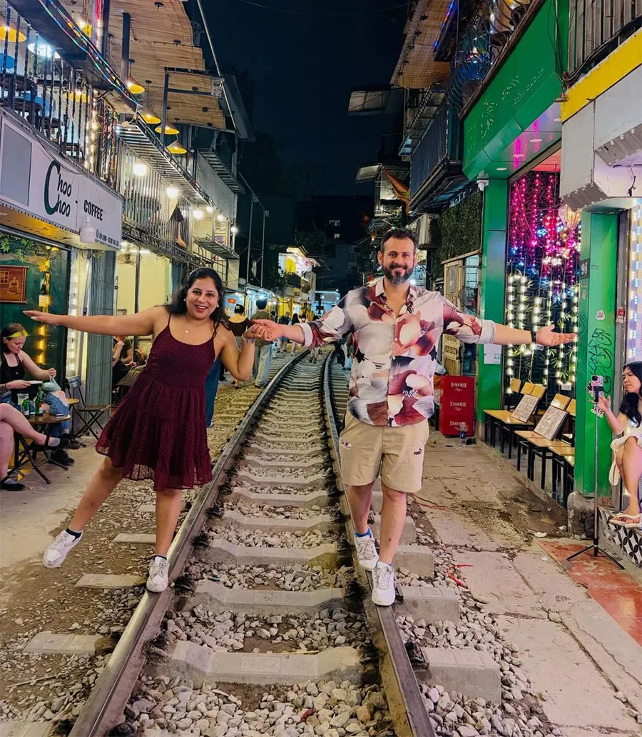 Is Hanoi Train Street Worth Visiting? An Honest Guide for First-Time Travelers 7 International visitors enjoying the lively evening atmosphere at Hanoi Train Street