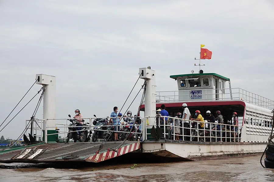Mekong Delta Ferry Experience: A Local Way to Cross the River 2 Mekong Delta local ferry carrying motorbikes, bicycles and residents across the river