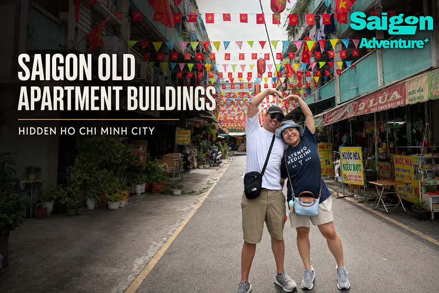 Saigon Old Apartment Buildings: A Walking Guide to Hidden City Life 1 Foreign visitors exploring colorful old apartment blocks in Ho Chi Minh City