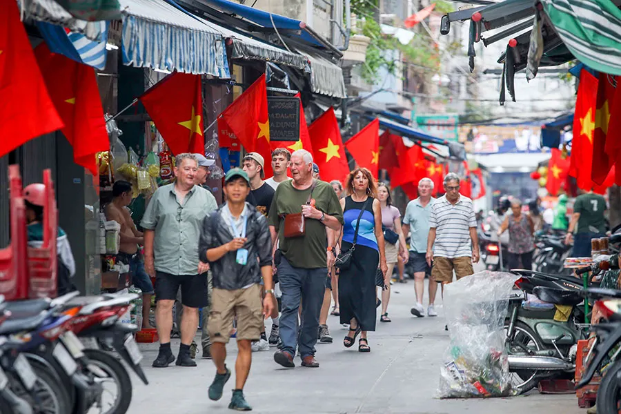 The Sounds of Saigon: What Everyday Street Noises Really Mean 1 Travelers exploring a residential alley filled with authentic Saigon neighborhood life