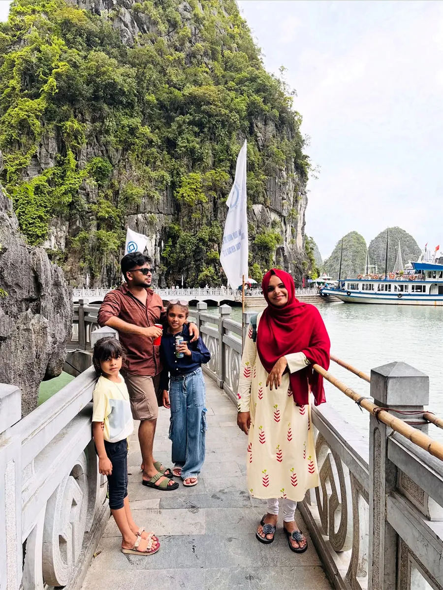 What Is a Typical Day Like on a Halong Bay Overnight Cruise? 3 ravelers taking memorable photos before starting their Halong Bay overnight cruise