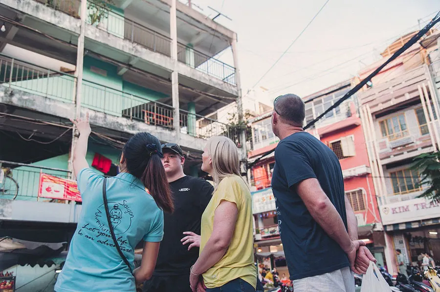 Saigon Old Apartment Buildings: A Walking Guide to Hidden City Life 4 Tour guide sharing the history and stories behind old apartment buildings in Ho Chi Minh City