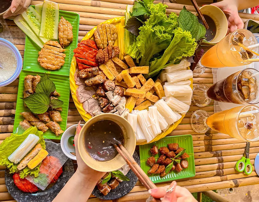 Bun Dau Mam Tom: Why Do Vietnamese People Love This Smelly Dish? 3 Traditional Vietnamese bun dau mam tom platter with crispy fried tofu, fresh rice vermicelli, boiled pork, fried spring rolls, cha com pork patties, aromatic herbs, and savory fermented shrimp paste.