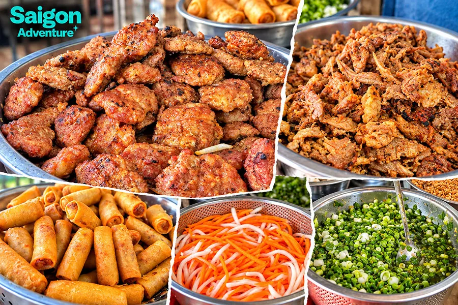 Bun Thit Nuong in Saigon: Where and How to Eat It 3 A bowl of bun thit nuong with grilled pork, rice noodles, fresh herbs, vegetables, peanuts, crispy spring rolls and fish sauce.