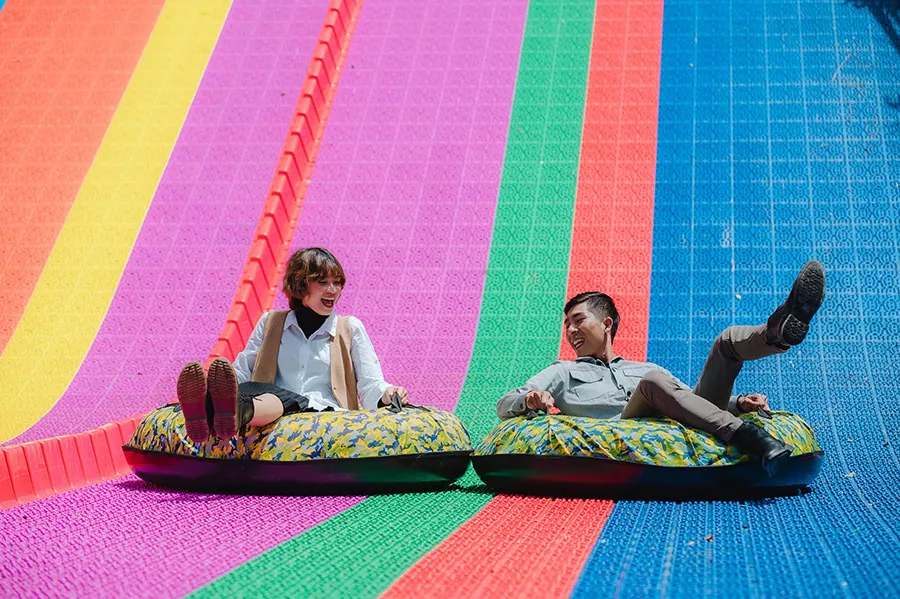 Dalat Wonderland: Is It Worth Visiting in 2026? 4 International tourists enjoying an exciting tubing slide experience at Dalat Wonderland