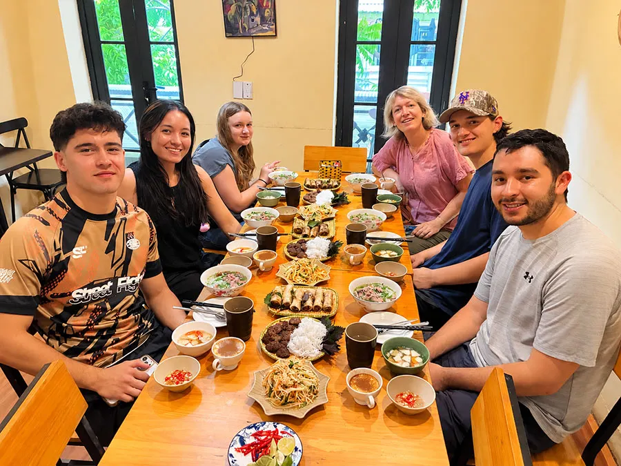 Hanoi cooking classes: What you cook and how to choose 8 Travellers enjoying the Vietnamese dishes they prepared during a Hanoi cooking class