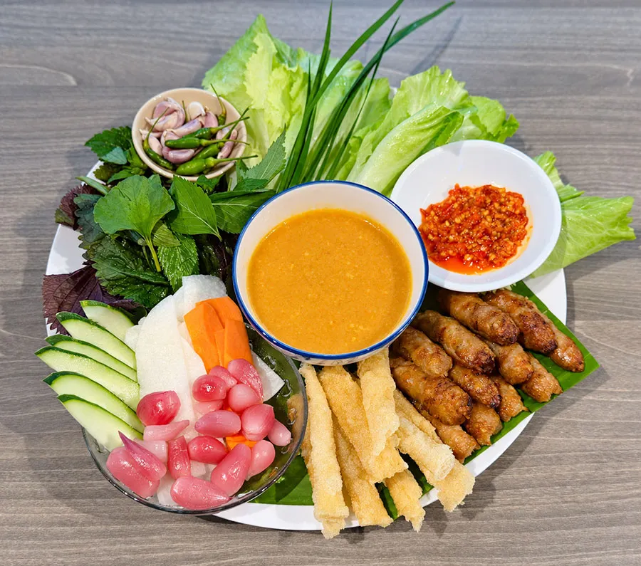 What to Eat in Dalat: Local Dishes Beyond the Night Market 6 Authentic Dalat grilled pork rolls served with fresh vegetables and Vietnamese herbs
