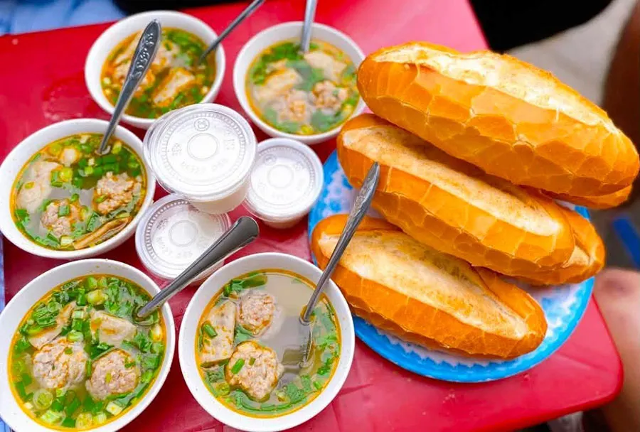What to Eat in Dalat: Local Dishes Beyond the Night Market 3 Must-try Dalat street food featuring hot pork meatball soup and Vietnamese baguette